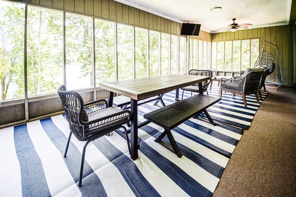 Large screened in patio overlooks the lake with plenty of room for dining or relaxing with a smart TV