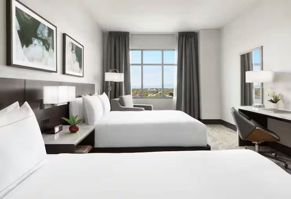 Wake up refreshed beside wide windows and plush bedding.