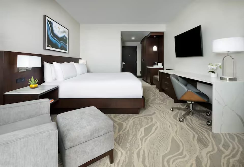 Settle in with a comfy bed, desk, and big TV.