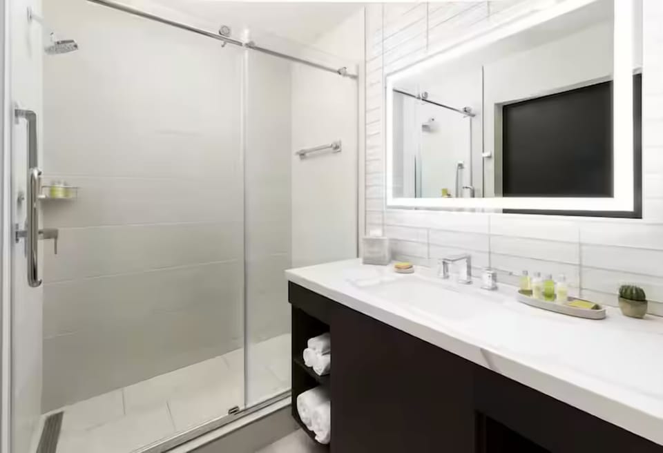 Refresh in a sleek glass shower with spa-like brightness.