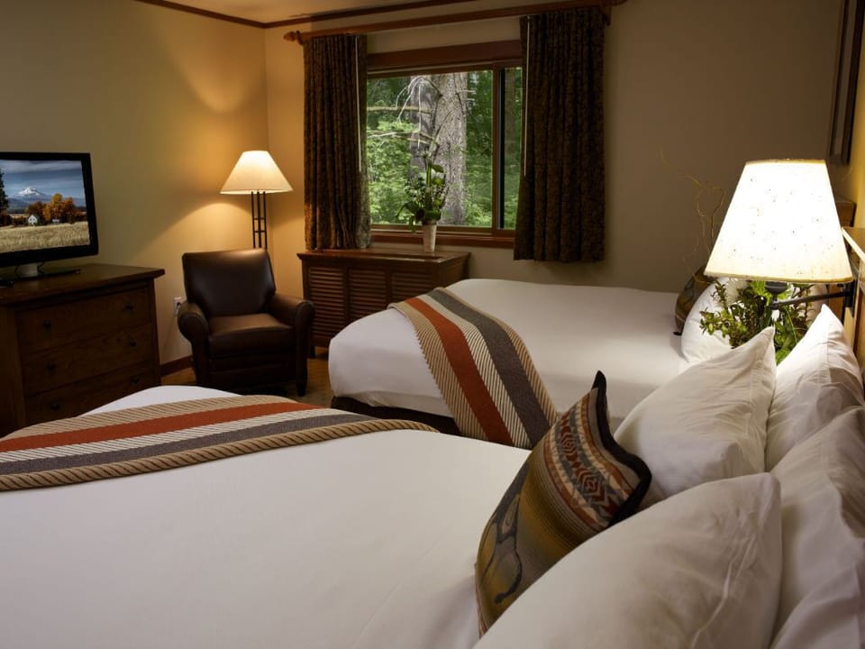 A restful space with plush bedding and soft lighting, offering a peaceful ambiance for unwinding.