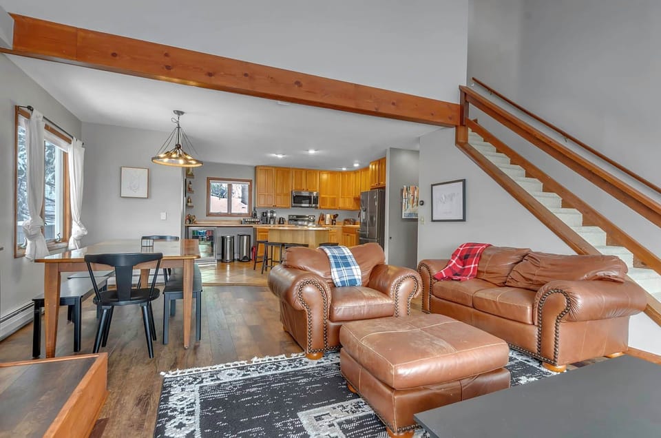 Open-concept great room connecting kitchen, dining, and lounge spaces for group stays