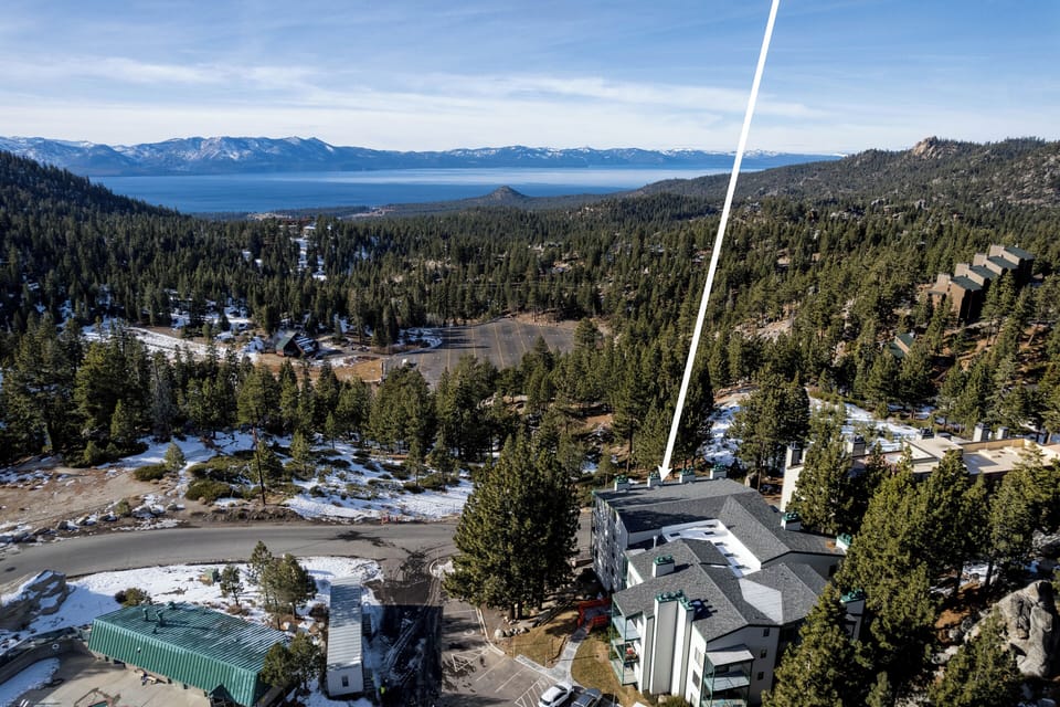 Charming condo building nestled in a peaceful mountain setting.