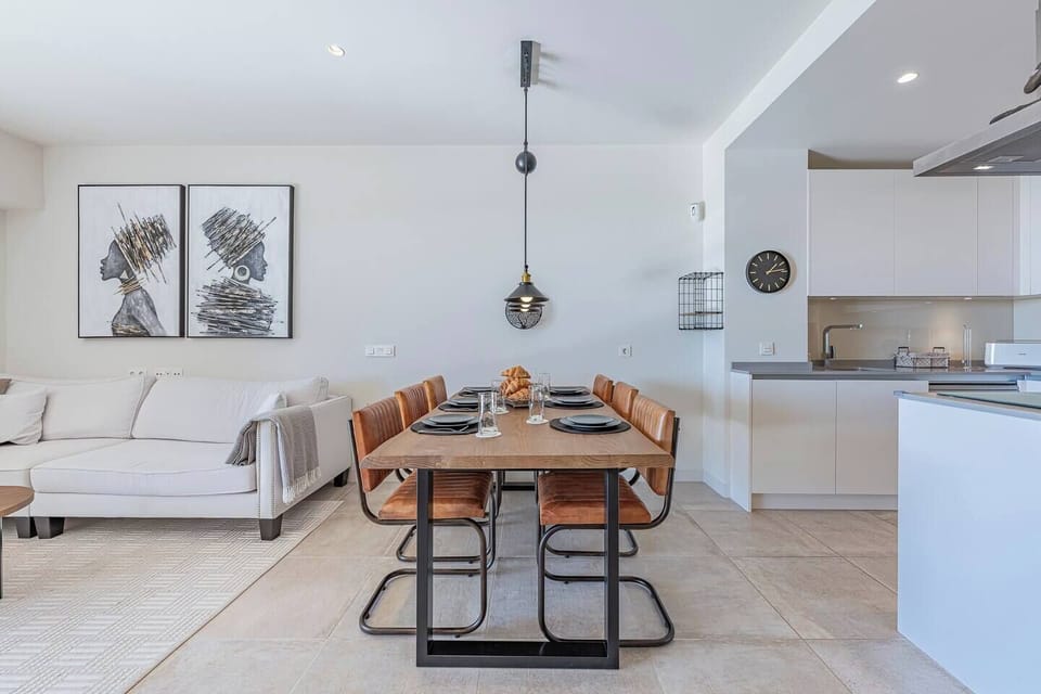 Spacious living room with L-shaped sofa, dining for 6, and terrace access with sea views. (4)