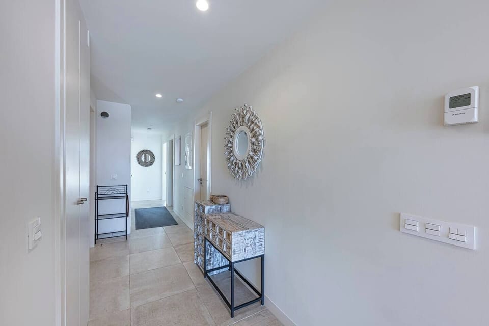 Spacious living room with L-shaped sofa, dining for 6, and terrace access with sea views. (9)