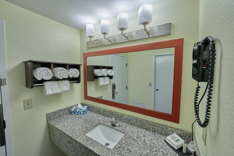 Refresh at a roomy vanity with bright, flattering lighting.