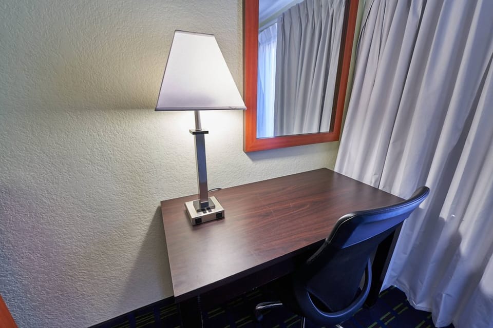 Focus comfortably at the bright desk beside the window.