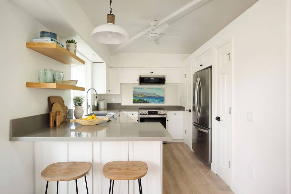 Dream Kauai kitchen with Hanalei Bay painting in the foreground.