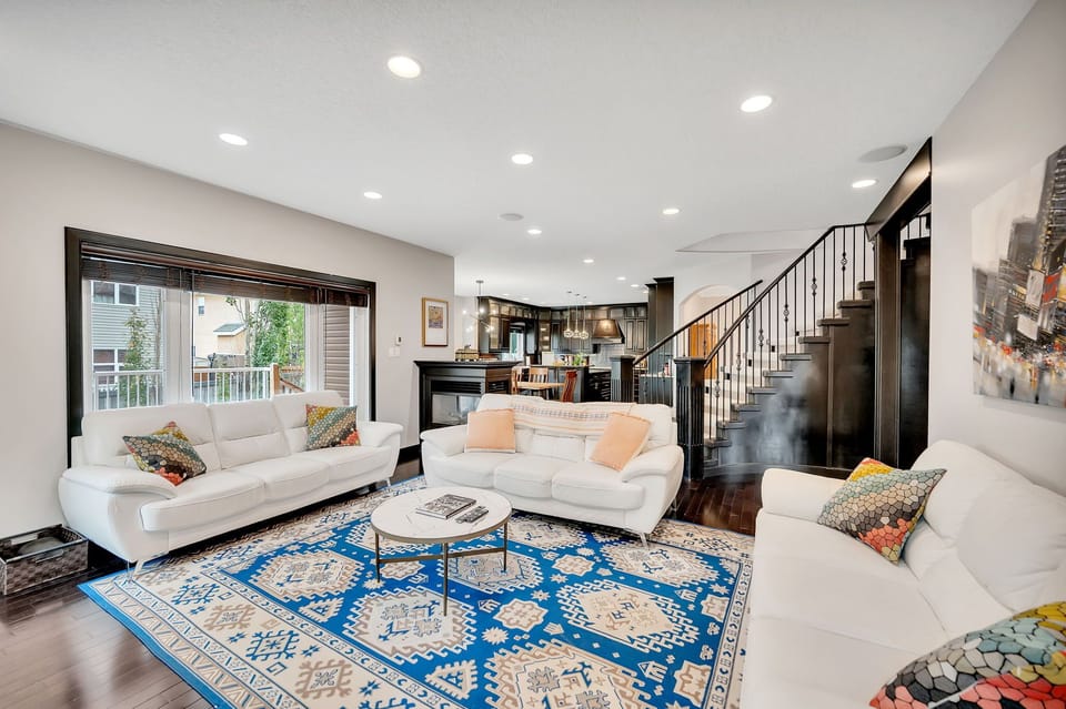 Unwind in the bright and inviting living room with cozy seating, smart TV, and warm touches that make you feel right at home.
