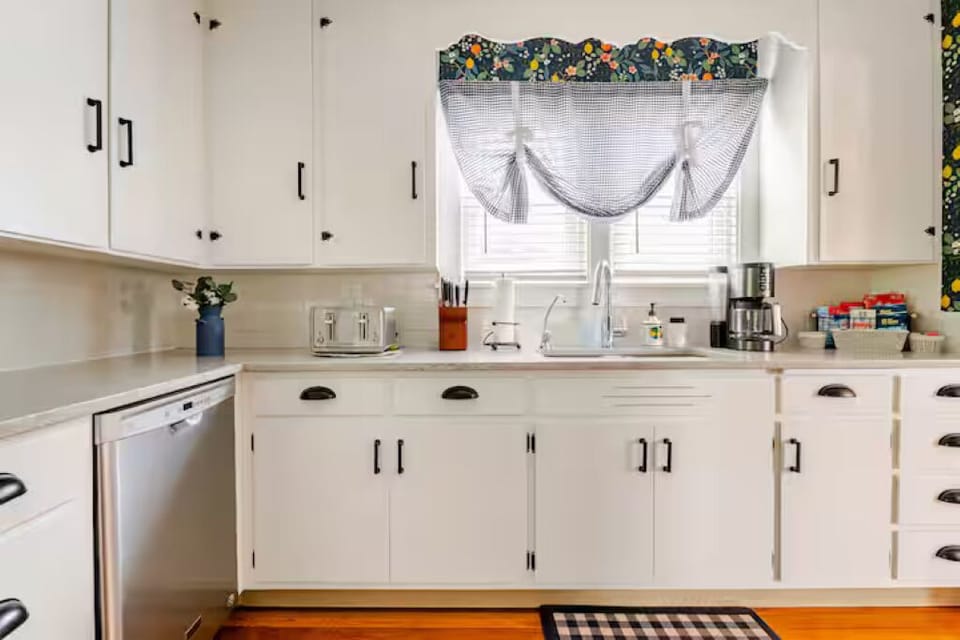 Dishwasher and plates, glasses, utensils, and cooking utensils offered.