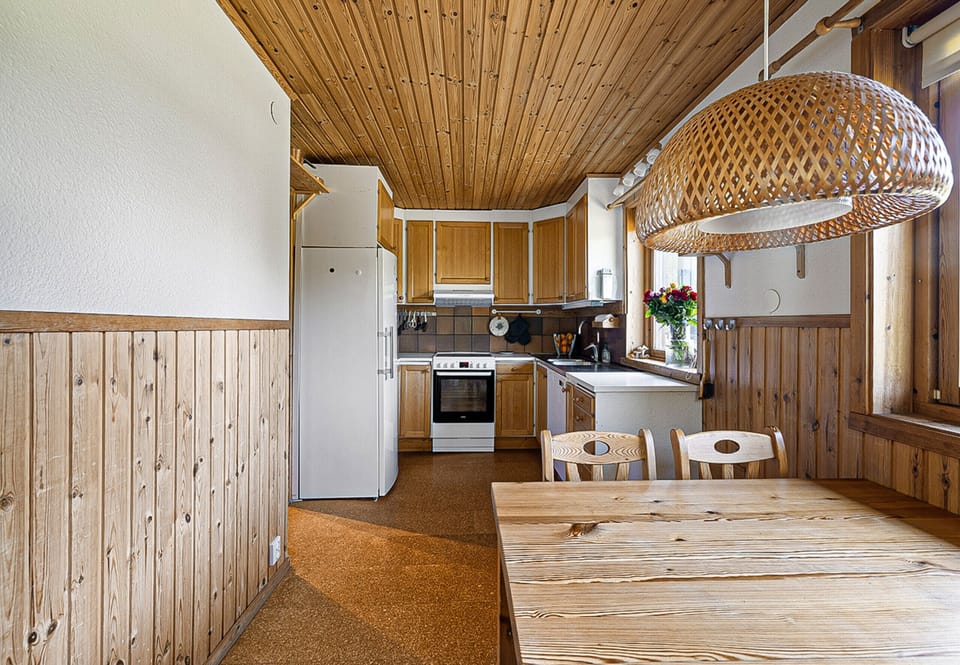 Kitchen with small kitchen table and window facing the water