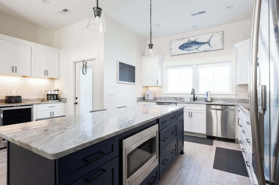 Modern fully-equipped kitchen with a large island and bar seating (seats 3) for casual dining (w/ stove, oven, microwave, toaster, Keurig, and more)
