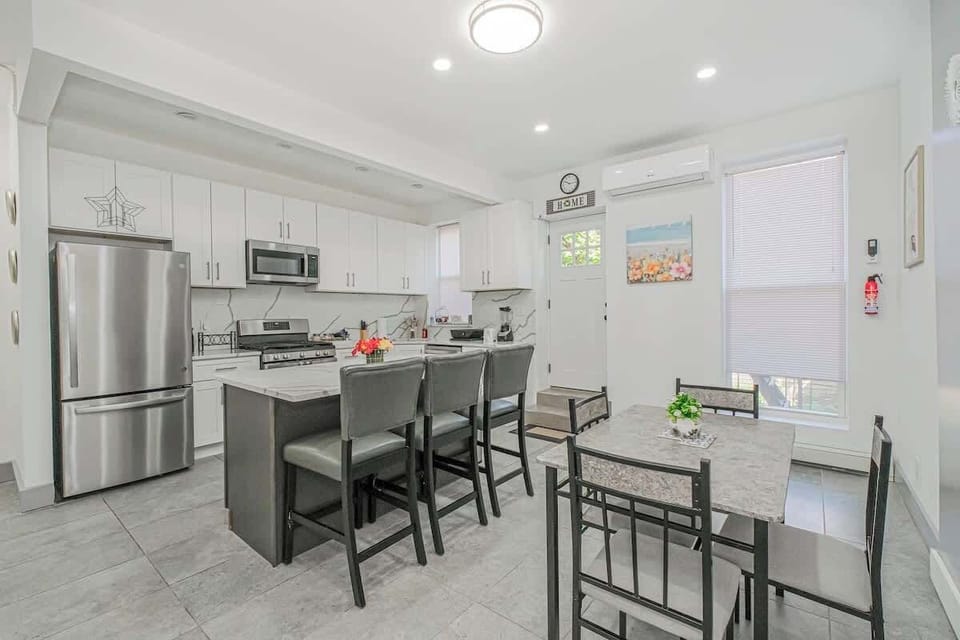 The dining area brings a warm and welcoming space to enjoy a meal or gather with loved ones. The large table comfortably seats everyone for a shared dining experience.
