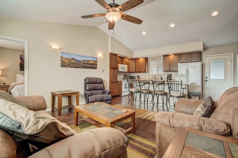 Relax and connect in the bright and open living area, featuring cozy seating, a Smart TV, and easy access to the dining and kitchen spaces.