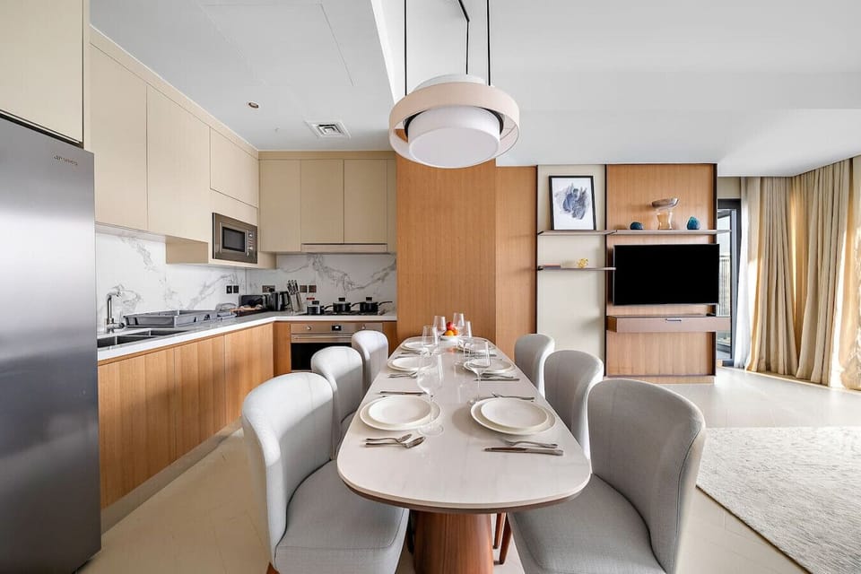 Open-concept dining flows from the chic kitchen to the living area.