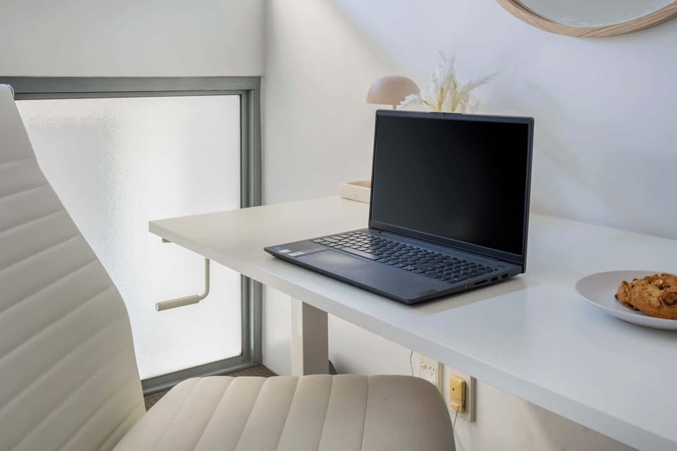 A stylish and functional workspace within the bedroom, featuring a desk and comfortable chair, ideal for working or studying in a peaceful, personal setting.