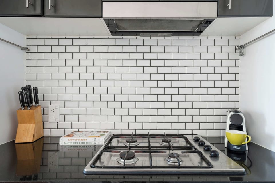A well-equipped kitchen featuring a stove, cutlery, and a coffee maker, offering everything you need for cooking and enjoying your favourite beverages.