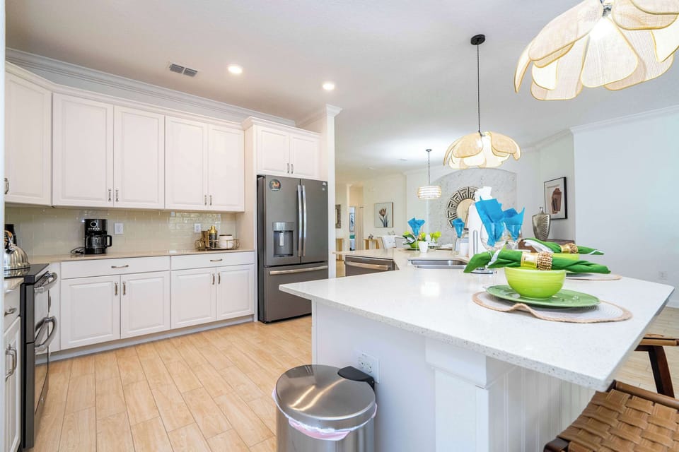 Chef-ready kitchen with quartz counters, stainless appliances and a spacious island-set for easy breakfasts and group cooking in a clean, airy modern space.