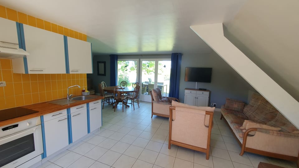 Kitchen, dining and seating areas.