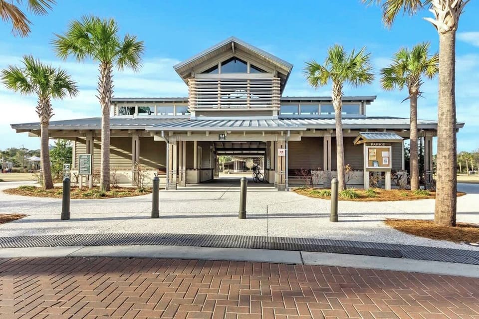 Modern coastal architecture with palm trees creates an inviting entrance to this beachside community facility.