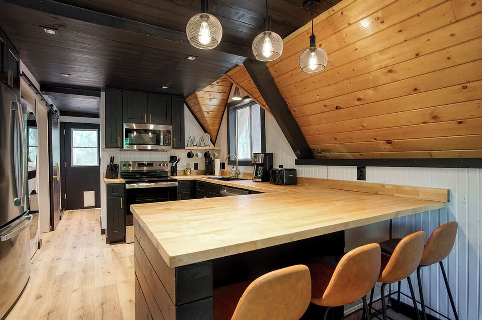 Modern updated, black, gold and butcher block kitchen, perfect for entertaining!