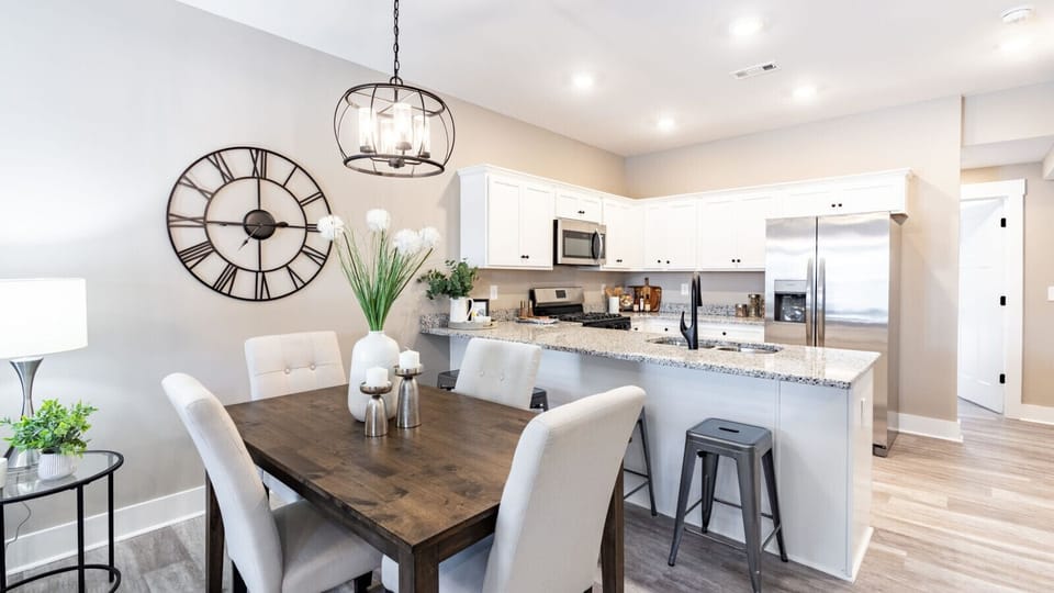 Fully equipped kitchen featuring stainless steel appliances, granite countertops, and an inviting dining area for family or group gatherings.