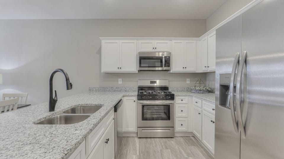 Modern kitchen featuring stainless steel appliances, granite countertops, and ample cabinet space—perfect for family meals and entertaining.