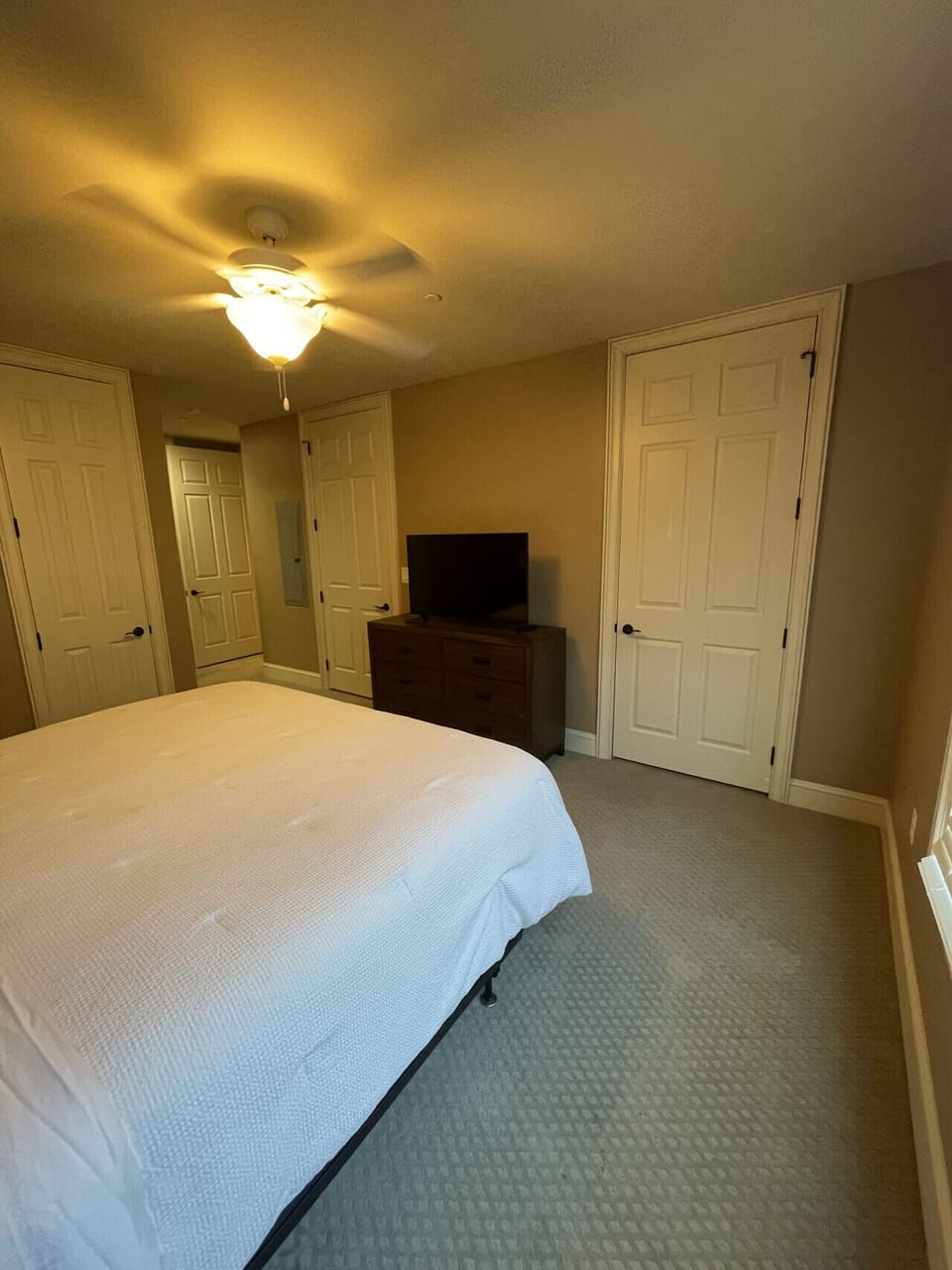 Relax in your bright and elegant bedroom at The Gateway Village, featuring a large bed and window view. Everything you need for a comfortable long-term stay in Murfreesboro.