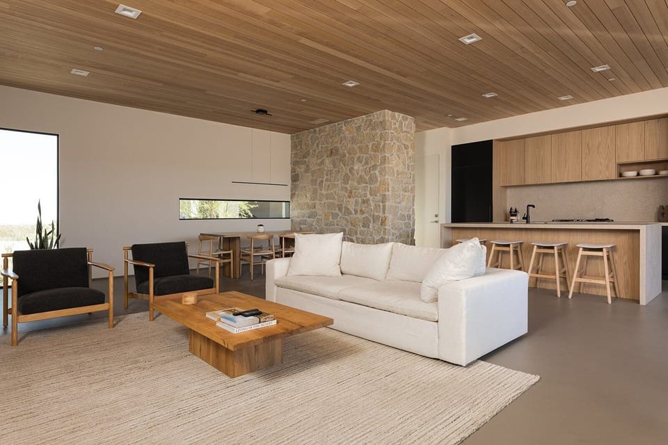 Plush elements complement the wood and stone finishes.