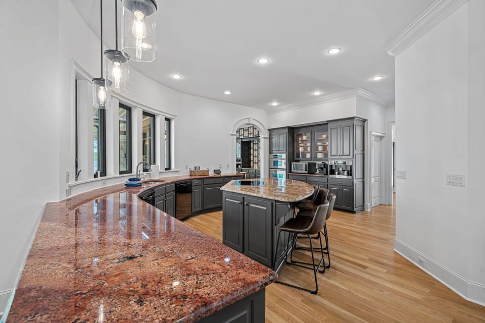 Fully stocked kitchen with large island seating 6.