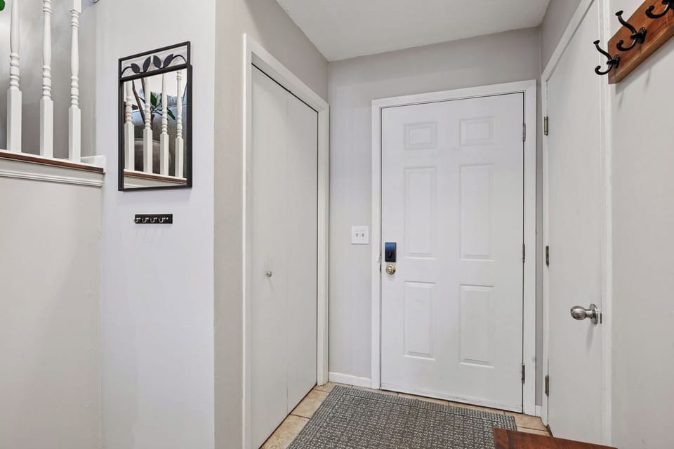 Front entryway to the home. Closet on the left, door to garage on the right. 