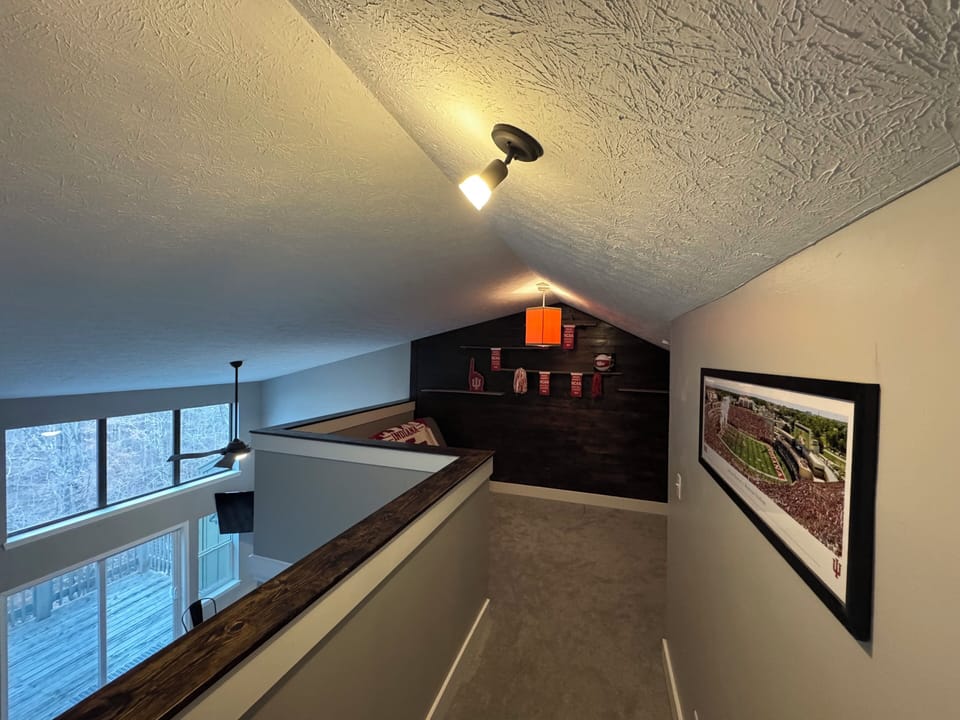 Private loft with futon and tv, includes air mattress for additional guests.