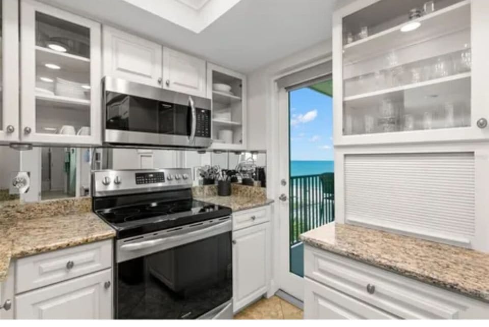 Door off kitchen to access patio overlooking the beach.