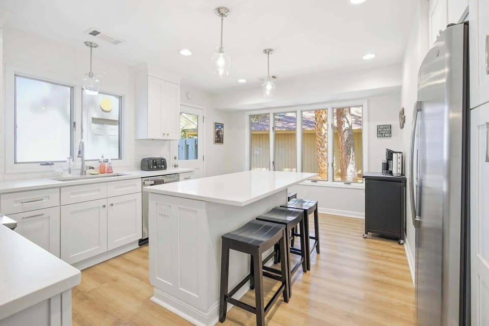 Modern kitchen with a large island and natural light from multiple windows