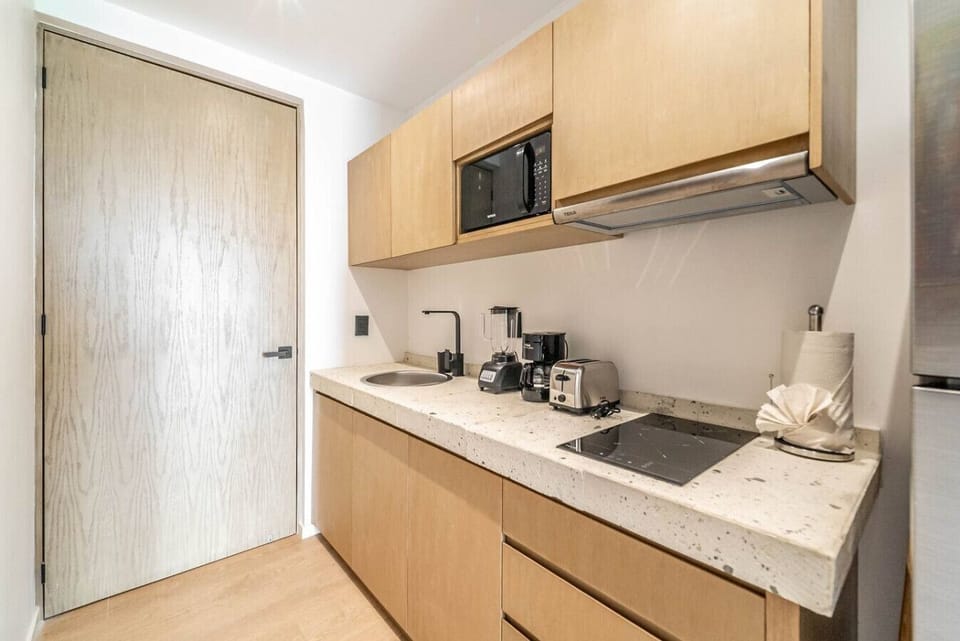 The kitchen is perfect for quick snacks or gourmet meals, offering a welcoming and functional space.