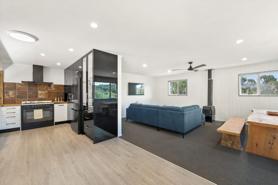 Open-plan kitchen/dining/living area with woodburner for winter