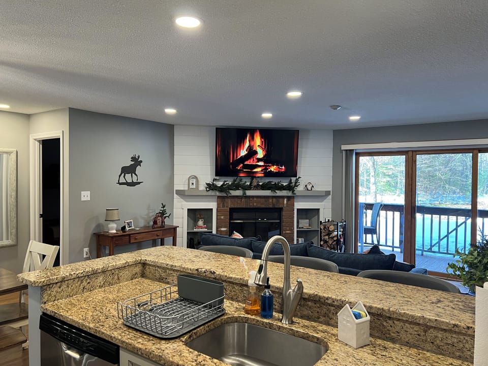 Large flat screen smart TV, and fireplace.
