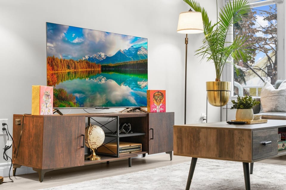Cozy entertainment setup with a large smart TV, stylish console.