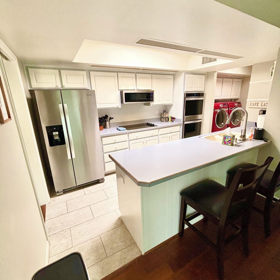 Full kitchen with bar top seating area