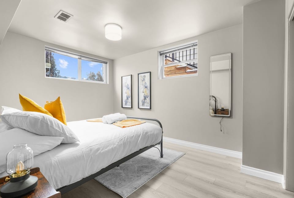Spacious bedroom with a king bed, fresh linens, and a large window