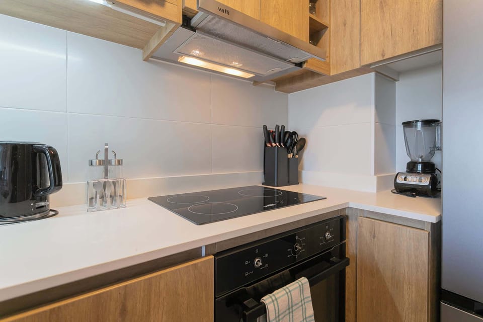 Cook your favorite meals in this sleek, modern kitchen equipped with all essentials.