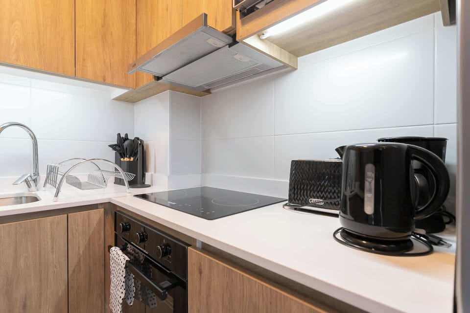 Experience the sleek design of a fully equipped modern kitchen, perfect for your culinary adventures.