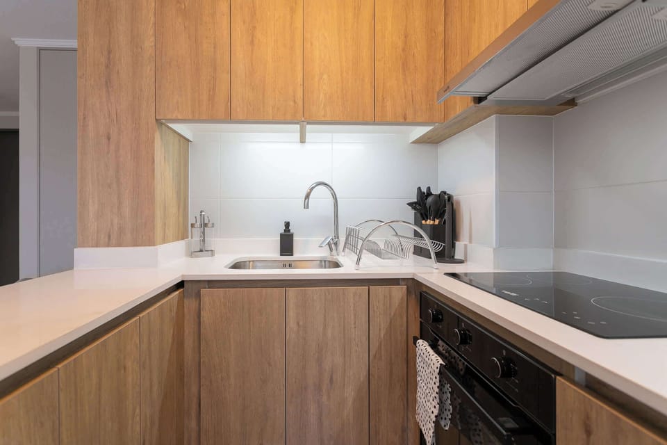 Experience cooking in a sleek, modern kitchen with all essentials at your fingertips.