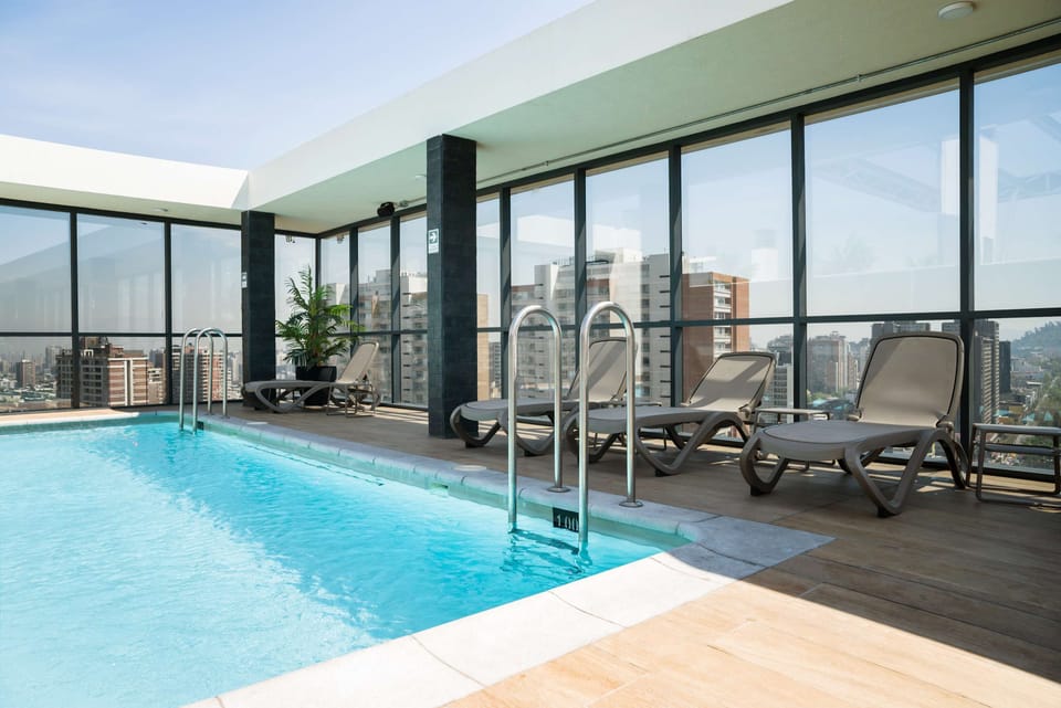 Relax by the rooftop pool with stunning city views, perfect for unwinding after a day of exploring.