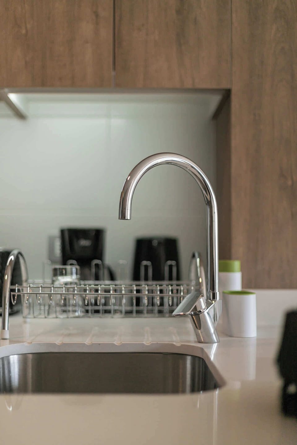 Sleek and modern kitchen with a stylish chrome faucet and practical amenities for your cooking needs.
