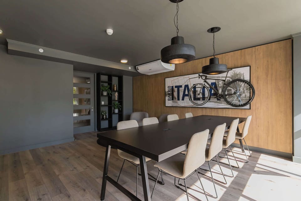 Modern meeting space with stylish decor and ample seating, ideal for work or gatherings. (Common Area)
