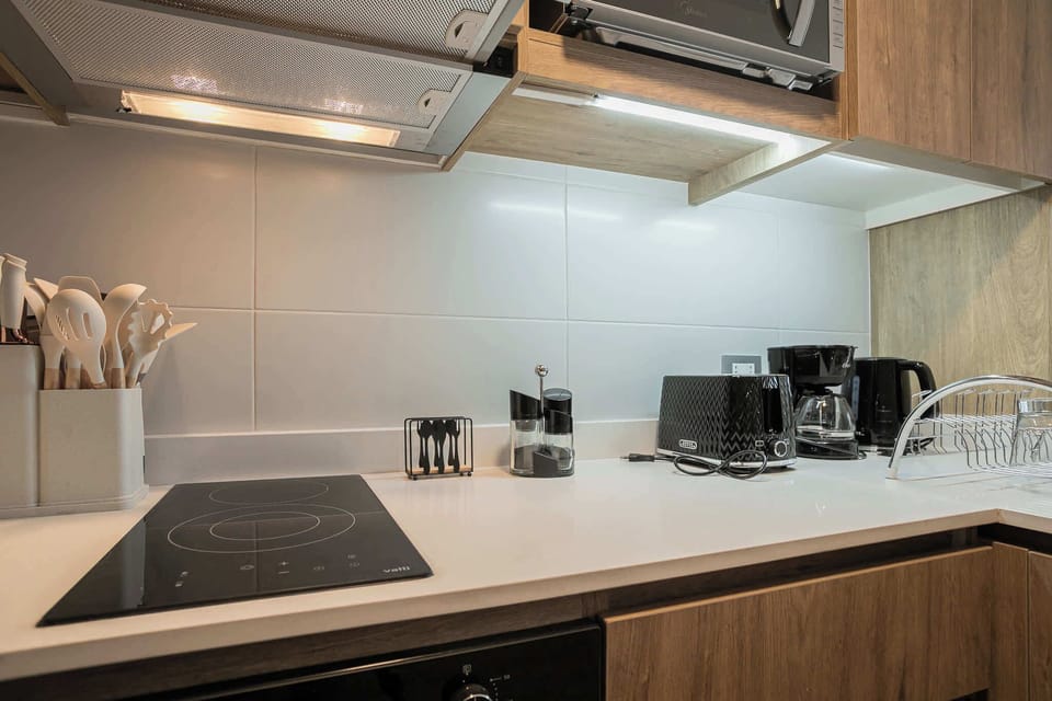 Experience culinary delight in this modern kitchen with top-notch appliances and ample workspace.