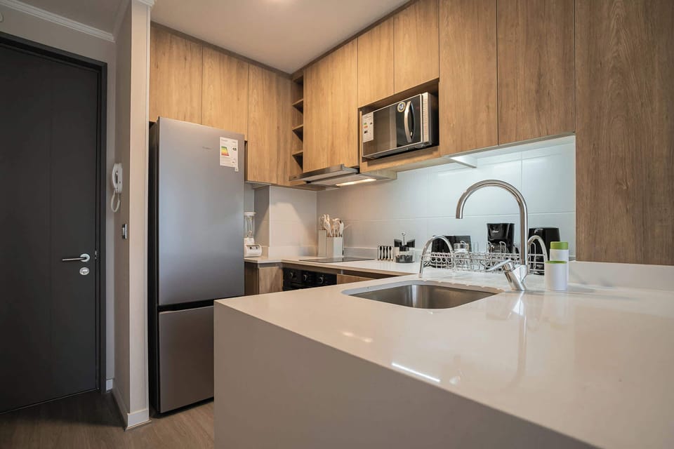 Sleek kitchen with top-notch appliances and ample counter space, perfect for culinary adventures.