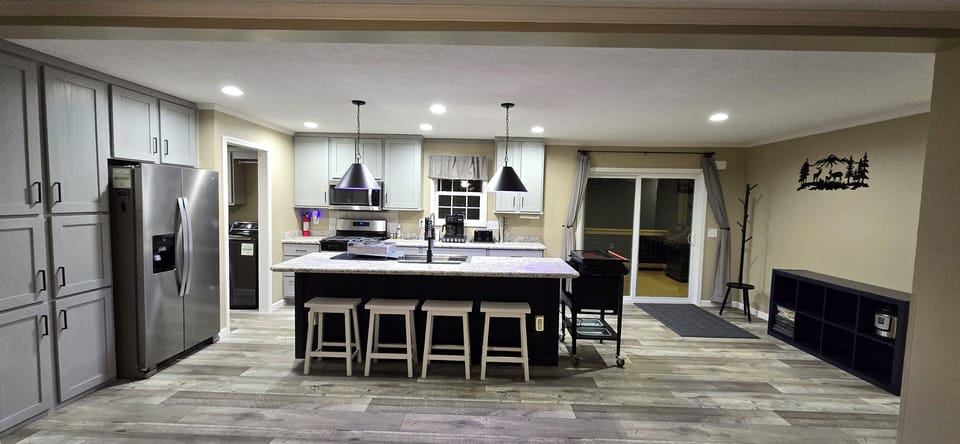 Sliding door to rear deck. Four counter bar stools. Kids and adults love it!