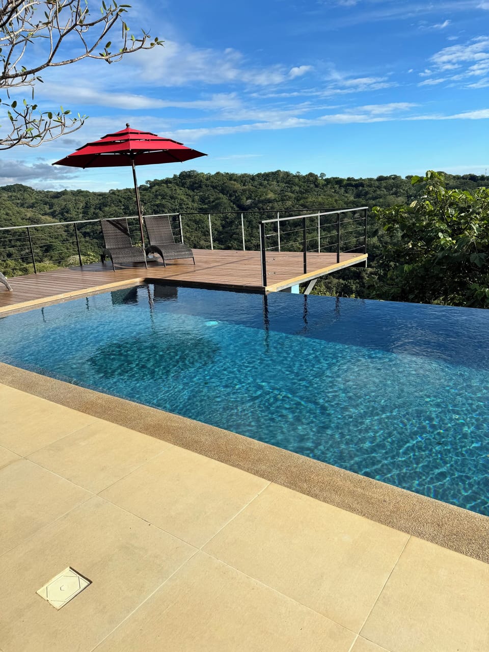 Yoga deck, pool and loungers with ocean and jungle views 